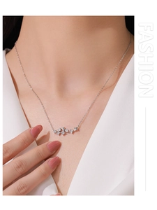 Close-up of 925 sterling silver star pendant necklace with cubic zirconia on model