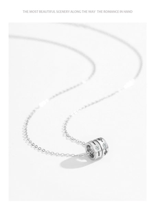 Macro detail of 925 silver cylinder pendant with inlaid crystals and star patterns