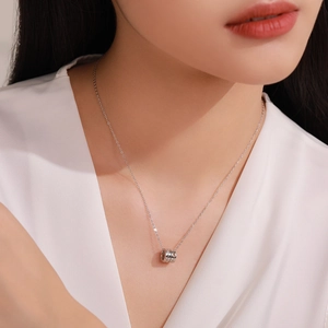 Minimalist 925 sterling silver cylinder necklace with sparkling zircon on a female model