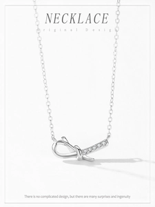 Macro detail of S925 sterling silver bow knot pendant with sparkling pavé crystals