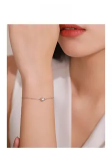 Detail view of S925 sterling silver thin bracelet with square bezel zircon on a female wrist