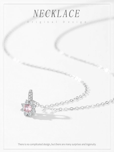 Macro detail of 925 silver sunflower pendant with pink zircon and micro-pave crystals
