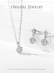 Detailed close-up of 925 silver necklace and floral earrings set with sparkling stones