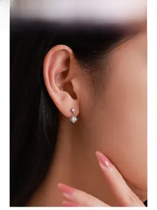 Macro view of sterling silver geometric drop earrings with sparkling zircon stones