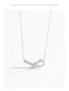 Close-up of S925 silver knot pendant necklace with delicate pavé cubic zirconia accents