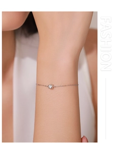 Detail of S925 sterling silver chain bracelet with a square zircon stone on wrist