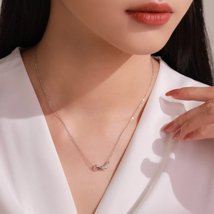 Elegant 925 sterling silver bow knot necklace with sparkling crystals on female model