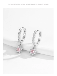 Detail of S925 silver flower earrings with pink crystal center and white cubic zirconia