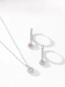 Detailed view of silver sunflower jewelry set with pink cubic zirconia petals