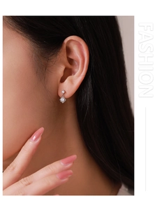 Close-up of 925 silver stud earrings with sparkling double square zircon stones on ear
