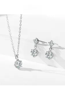 Macro detail of S925 sterling silver necklace and stud earrings set with sparkling stones