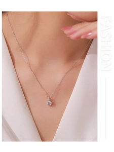 Close-up of 925 sterling silver sunflower pendant with pink zircon on female neck