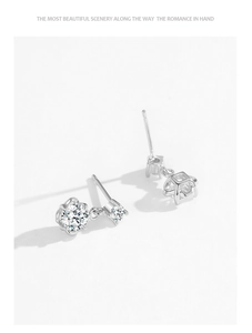 Macro view of 925 silver double zircon flower stud earrings with claw setting details