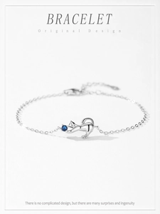 Detail of S925 sterling silver kitten bracelet featuring a blue zircon paw pendant