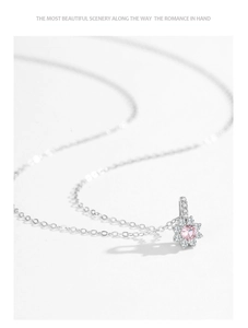 Detail of S925 silver necklace with pink zircon sunflower pendant on white background