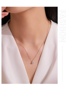 Detail of 925 sterling silver necklace with square cubic zirconia on a model's neck