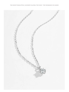 Macro shot of S925 sterling silver necklace with classic six-prong sparkling diamond pendant