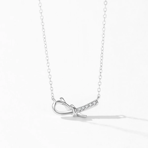 Elegant S925 sterling silver bow knot pendant necklace with zircon gemstones on white base
