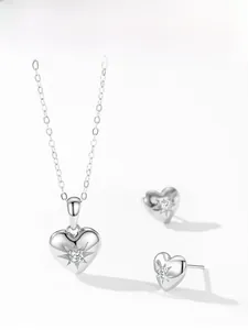 Close-up of 925 silver heart necklace and earrings set with starburst engraving