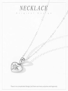Detailed macro view of S925 silver heart necklace with starburst engraving and gem