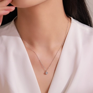 Minimalist 925 sterling silver flower necklace with sparkling zircon on a female model