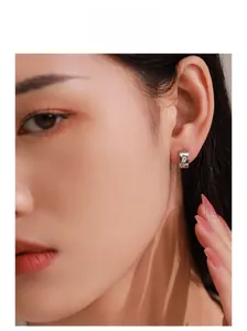 Close-up of a model wearing a 925 silver C-shape stud earring with rectangular zircon