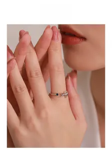 Close-up of S925 silver cat ring featuring a blue sapphire stone on model's finger