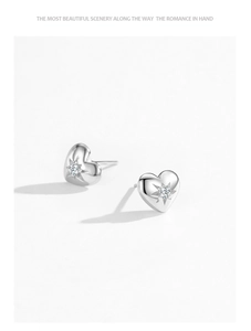Detailed view of S925 silver heart stud earrings with starburst cubic zirconia setting