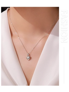 Macro detail of S925 sterling silver heart necklace with sparkling starburst stone
