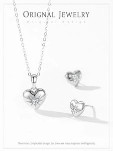 Detail shot of heart-shaped 925 silver jewelry set with starburst engraving and crystal