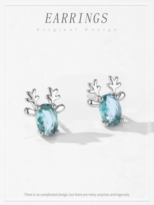 Détails macro de boucles d'oreilles renne en argent avec pierres bleu sarcelle