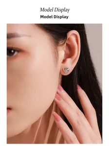 Detail of 925 sterling silver heart earring with starburst zircon on a female model