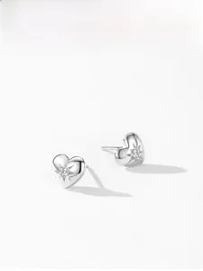 Close-up of 925 silver heart earrings with starburst setting and sparkling zircons