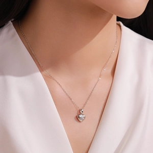 Elegant S925 sterling silver heart necklace with starburst diamond pendant on neck