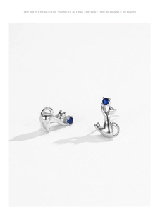 Detailed view of S925 sterling silver cat earrings with blue round gemstones