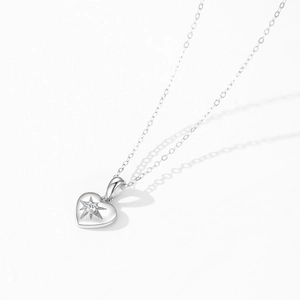 Sparkling S925 sterling silver heart necklace with starburst texture and small zircon pendant