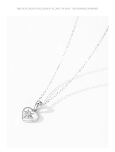 Detail showing 925 silver heart necklace with starburst setting and clear zircon stone