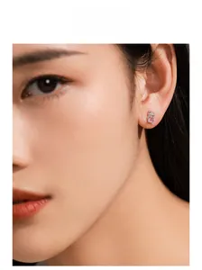 Close-up model display of a 925 silver cat earring featuring a pink oval gemstone