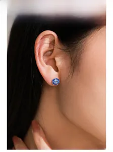 Close-up of S925 silver oval blue zircon stud earring on a model with enamel finish