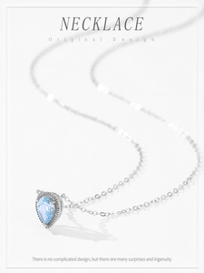 Detail of 925 sterling silver necklace with teardrop blue gemstone and beaded edge