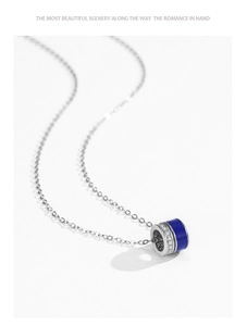 Close-up of S925 silver cylinder necklace with blue enamel and cubic zirconia stones