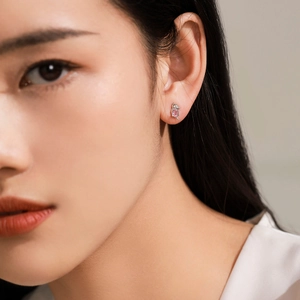 Cute 925 sterling silver koala stud earrings with pink gemstone on female model ear