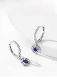 Detailed view of S925 sterling silver stamp and blue gemstones on silver earrings
