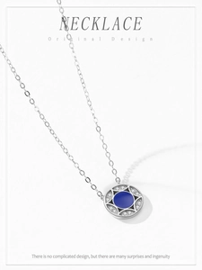 Macro shot of S925 silver necklace with blue enamel pendant and sparkling zirconia stones