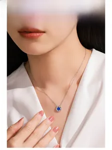 Detail showing the S925 silver necklace with a blue star pendant worn by a model