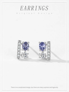 Detail view of S925 silver stud earrings with oval purple gemstone and cubic zirconia