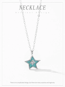 Detail of 925 sterling silver star pendant with turquoise enamel and sparkling zircon