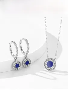 Detail of 925 silver star jewelry set with blue enamel and pavé small crystals