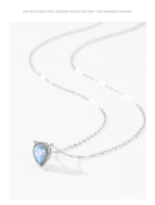Detailed macro view of pear-shaped blue gemstone pendant with vintage silver beaded border