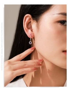 Close-up of elegant 925 sterling silver star earrings with deep blue enamel inlay